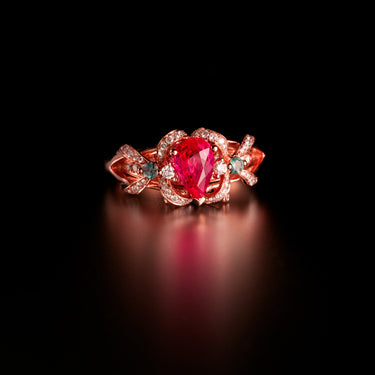18k rose gold ring with pear-shaped natural ruby, round alexandrites, and diamond accents